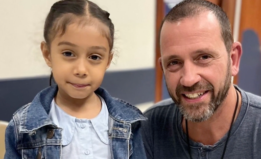 Michael Burghardt with a young patient during a Gift of Life International mission to El Salvador.